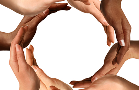 Hands of different colours forming a circle symbolizing the globe